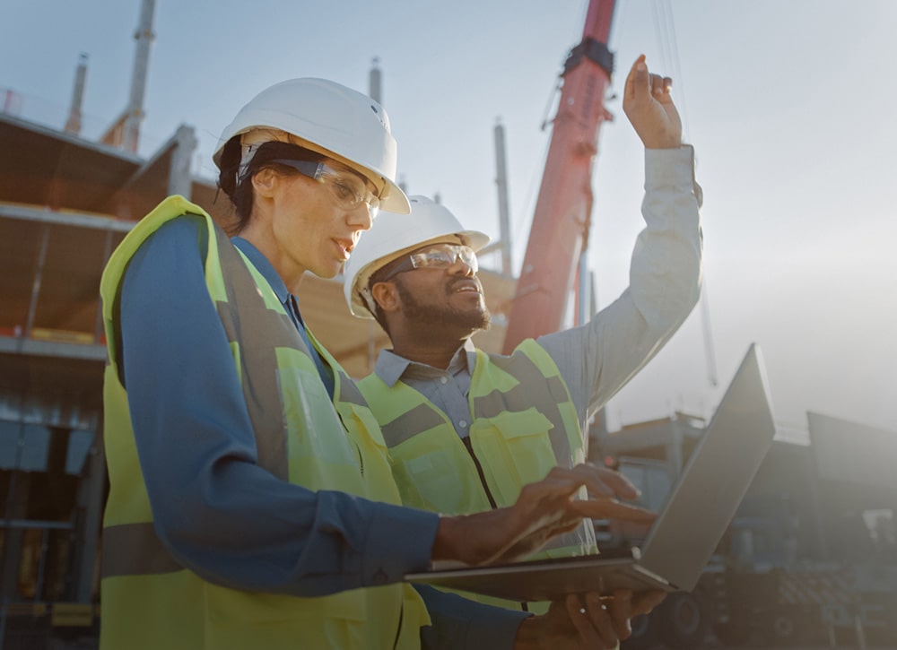 Tradespersons in yellow vests on a site