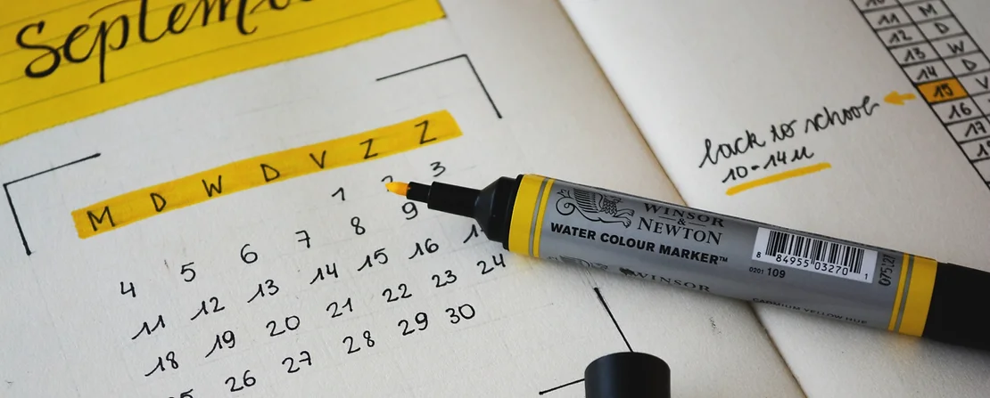 Yellow marker sitting on highlighted calendar